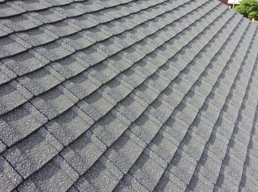 A newly installed asphalt shingle roof with flat, even courses